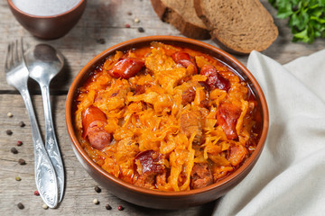 Braised cabbage with meat and smoked sausage. Traditional Polish and Lithuanian dishes. 