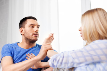 domestic violence, abuse and conflict concept - unhappy couple having argument at home
