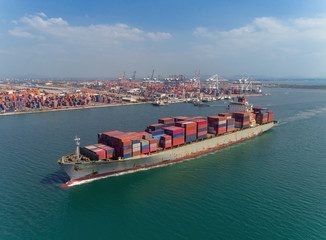 Container ship driving from sea port logistics business import export, shipping or transportation concept background.