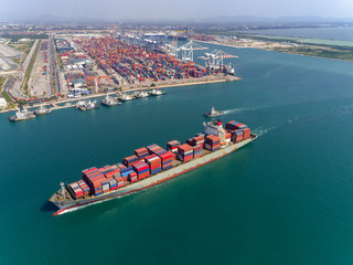 Aerial view container ship driving from seaport for logistics or shipping business , import export or transportation.