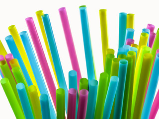 Coloured straws, bundles on a white background