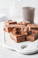 Raw vegan chocolate fudge on a white board.