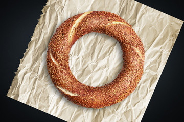 Fresh Turkish bagel on a wrinkled paper.
