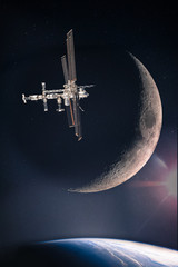 Collage with space station at the starry galaxy above the planet Earth and on the background of waxing crescent moon, elements of this image are furnished by NASA. © elen31