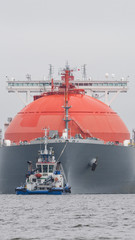 LNG TANKER - Ship and tugs are maneuvering at the gas terminal in Swinoujscie