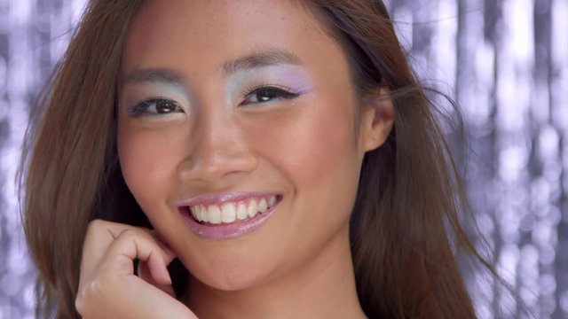 thai asian model smiling to the camera wear colour highlight eyeshadows