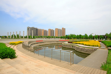 Urban construction scenery, pond and stainless steel rail