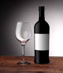 a bottle of wine with an empty glass