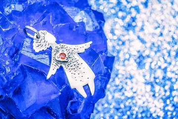 Silver pendant angel with a red heart on a blue stone
