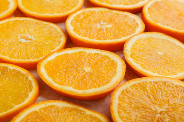Abstract background with citrus orange slices on parchment paper. Close up. Top view. Studio photography.