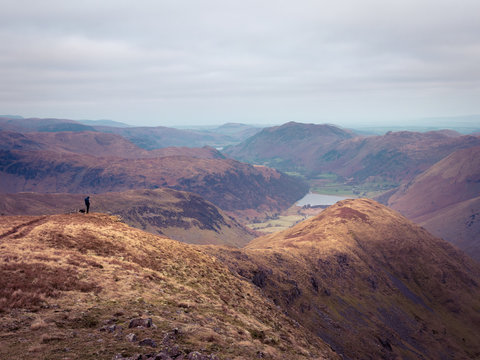 Photographer checking his shot above Middle Dodd, Lake District, UK