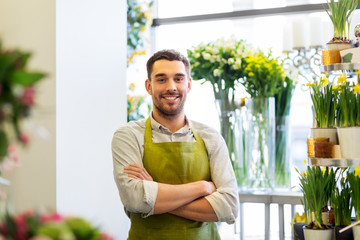 sale, small business and floristry concept - happy smiling florist man or seller at flower shop