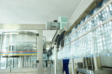 Pet bottle with natural water manufacturing. Soft focus