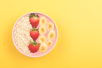 Smoothie bowl on yellow background
