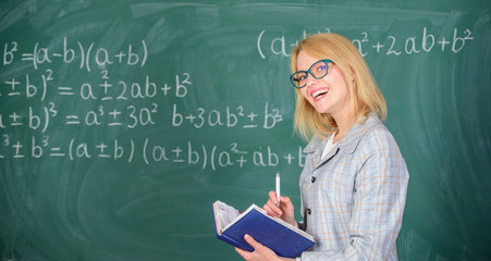 Woman teaching near chalkboard in classroom. Qualities that make good teacher. Effective teaching involve prioritizing knowledge and skills. Effective teaching involve acquiring relevant knowledge