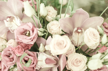 Bouquet with orchids and roses on a beautiful background