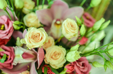 Bouquet with orchids and roses on a beautiful background