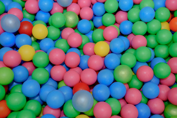 Balls plastic multi-colored. Background of children's globe for playing.