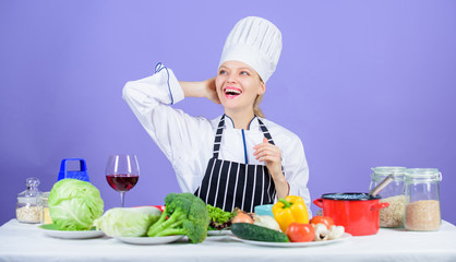 Gourmet main dish recipes. Girl in hat and apron. Delicious recipe concept. Cooking healthy food. Fresh vegetables ingredients for cooking meal. Lets start cooking. Woman chef cooking healthy food