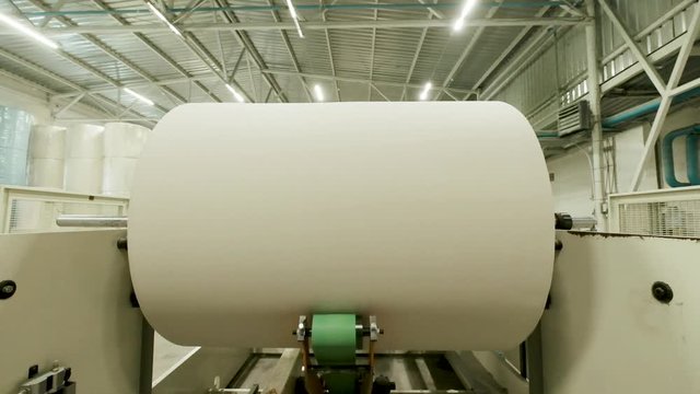 Winding A Large Roll Of Paper In A Paper Mill.