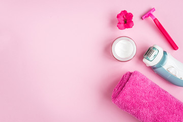 Obraz na płótnie Canvas Towel, cream, razor and flower on pink background. Flat lay. Skincare.