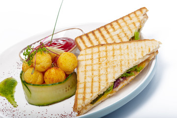 Sandwich with ham, cheese, tomatoes, lettuce, and toasted bread. Top view isolated on white background.