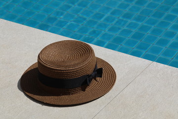 Fototapeta na wymiar Near the pool is a straw hat