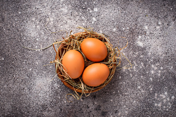 Fresh raw brown eggs in bowl.