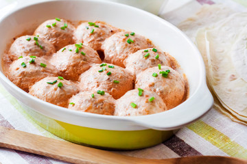Chacken meatballs baked in creamy tomato sauce