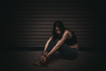 Asian hostage woman Bound with rope at night scene,The thieves kidnapped for ransom,thailand people