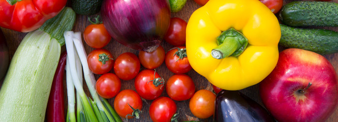 Set of various organic raw fruits and vegetables on wooden surface, view from above. Top view. Close-up.