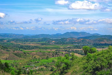 Fototapeta na wymiar Vast landscape of Central Vietnam with distant mountains. Lush green vegetation.