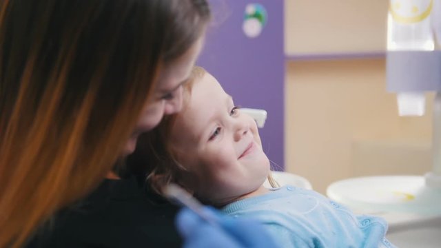 Medicine, dentistry. Female dentist examines the oral cavity of little baby