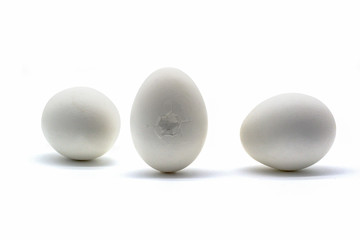 Cracked white eggs isolated on white background