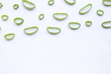 Aloe vera slices on white background.