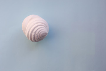 White marshmallows on blue background. Flat lay, copy space