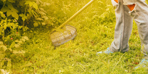 man mows the grass close up
