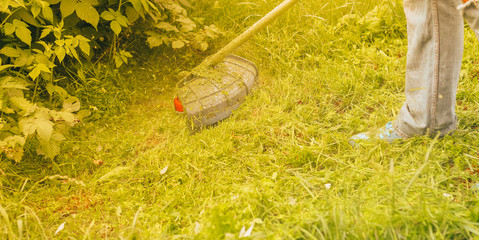 man mows the grass close up
