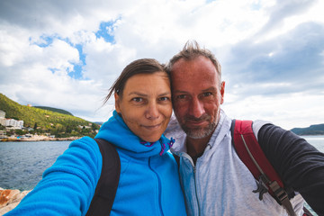 Happy couple taking selfie on the background of the bay Kas city