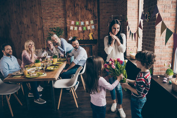 Close up photo of gathered relatives in house table little small
