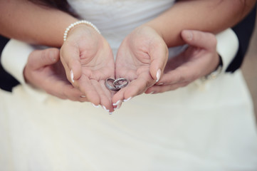 Beautiful wedding shoes with high heels and a bouquet of colorful flowers in sunset light, decorations, preparing for the wedding, details