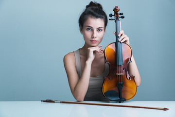 Portrait of a beautiful young woman sitting at the table