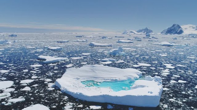 Antarctica Melting Blue Water Iceberg Aerial View. Antarctic Ocean Environment. Arctic Ice Nature Landscape of Global Warming and Climate Change Concept Top Drone Shot Footage 4K (UHD)