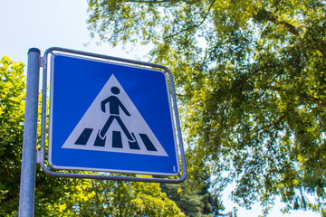Blue Crosswalk sign at the street