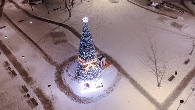 Christmas tree in town square, aerial smooth motion