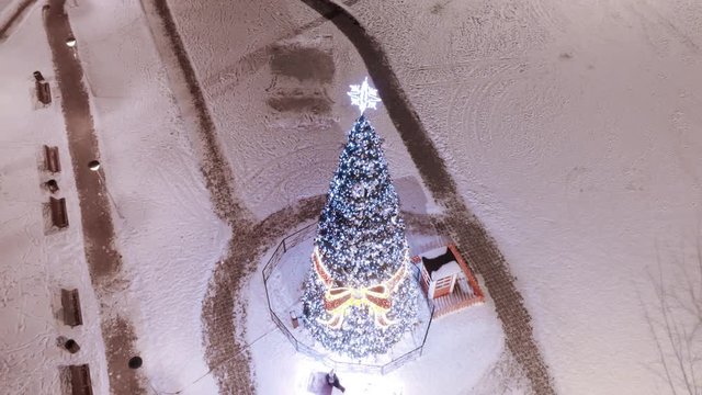 Christmas tree in town square, aerial smooth motion