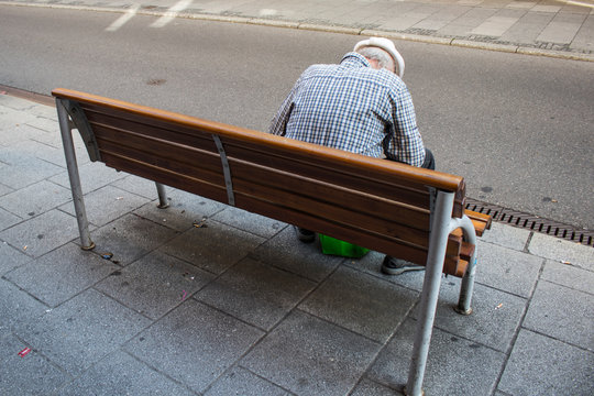 Old single man sitting on a bench