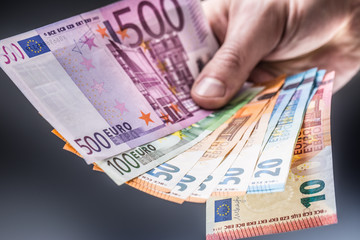 Male holding euro banknotes in his hands