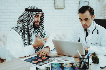Doctor Consulting Arabic Man Visiting Hospital