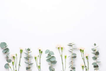 Flowers and eucaaliptus composition. Pattern made of various colorful flowers on white background. Flat lay stiil life.